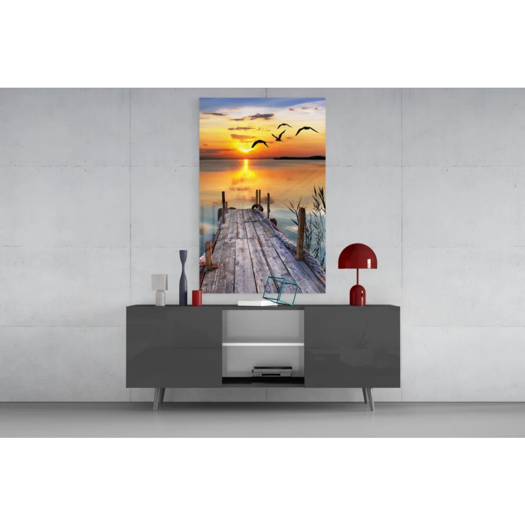 Sunset pier glass wall art with flying birds over calm water