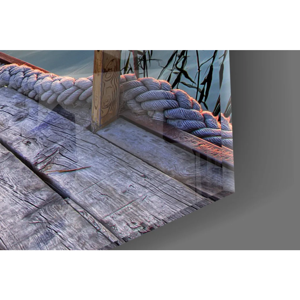 Thick braided rope on weathered dock in glass wall art with birds