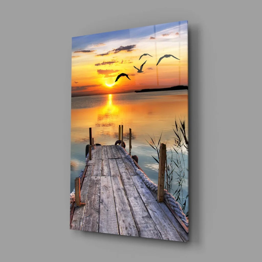 Serene sunset glass wall art with flying birds over water