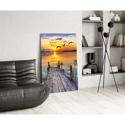 Sunset pier glass wall art with flying birds over calm dock