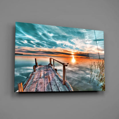 Sunset dock glass wall art with teal orange sky reflection on calm water