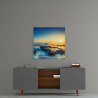 Serene ocean sunset glass wall art print on vibrant blues and golds