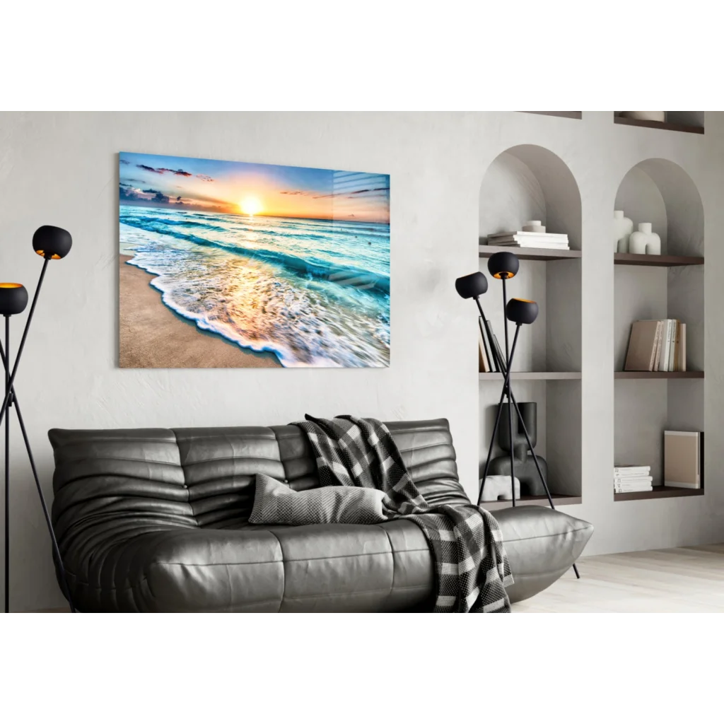 Beige turquoise beach sunset glass wall art above gray leather sofa