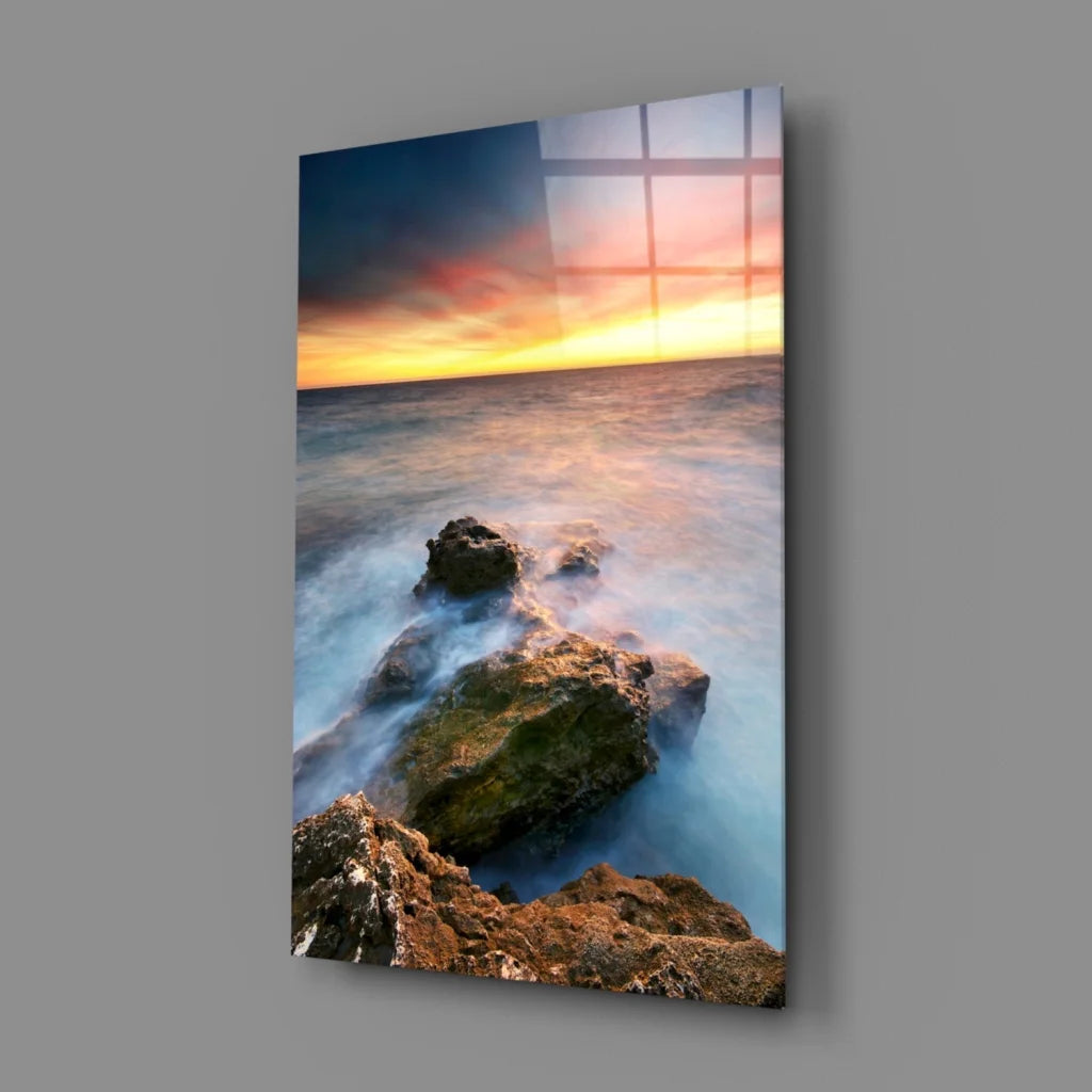 Serene coastal sunset glass wall art with flowing water and rocks