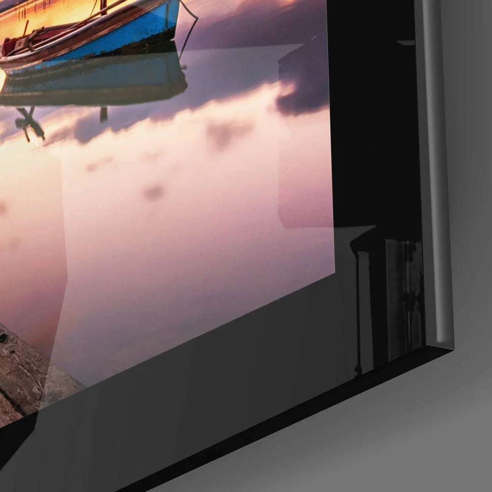 Serene sunset glass wall art with blue boat reflection in calm water