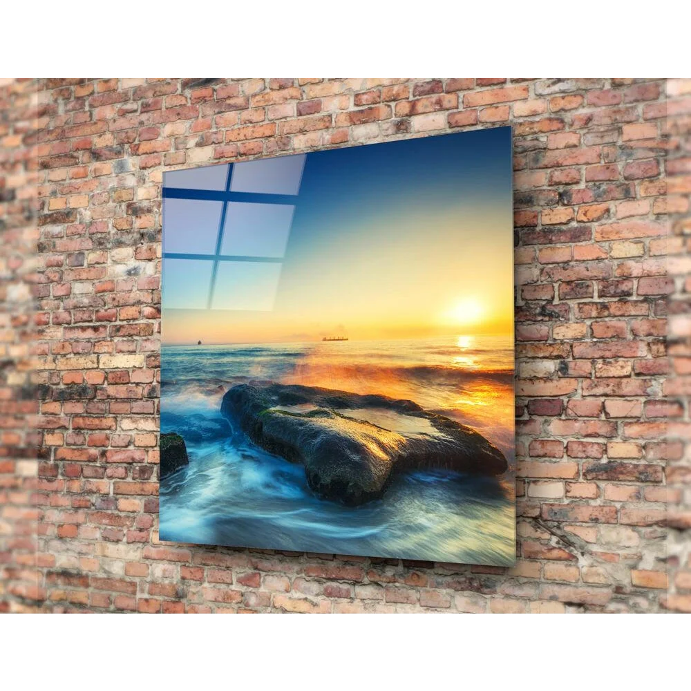 Vibrant sunset glass wall art on ocean waves and rocks, brick mount