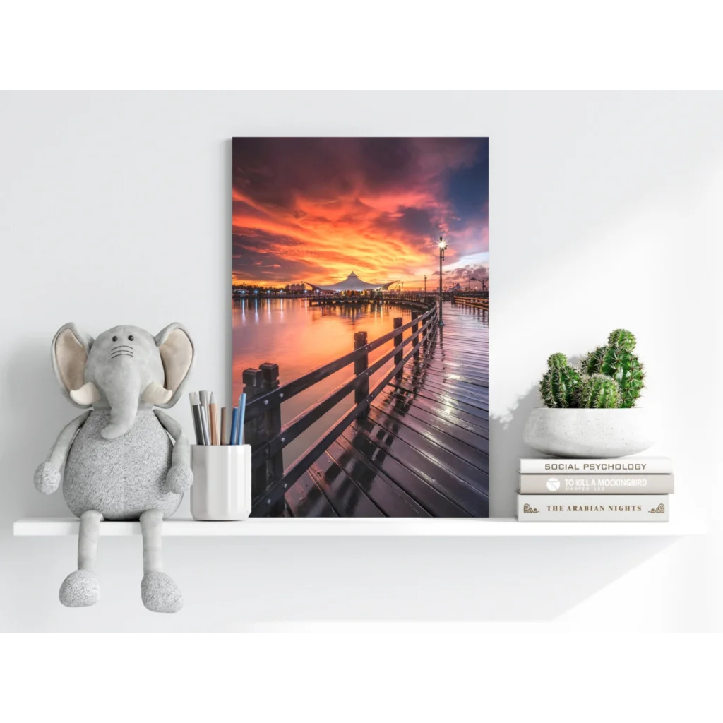 Vibrant sunset pier on Insigne aluminum print with reflective water and orange-pink clouds