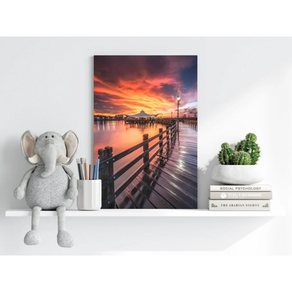 Vibrant sunset pier on Insigne aluminum print with reflective water and orange-pink clouds