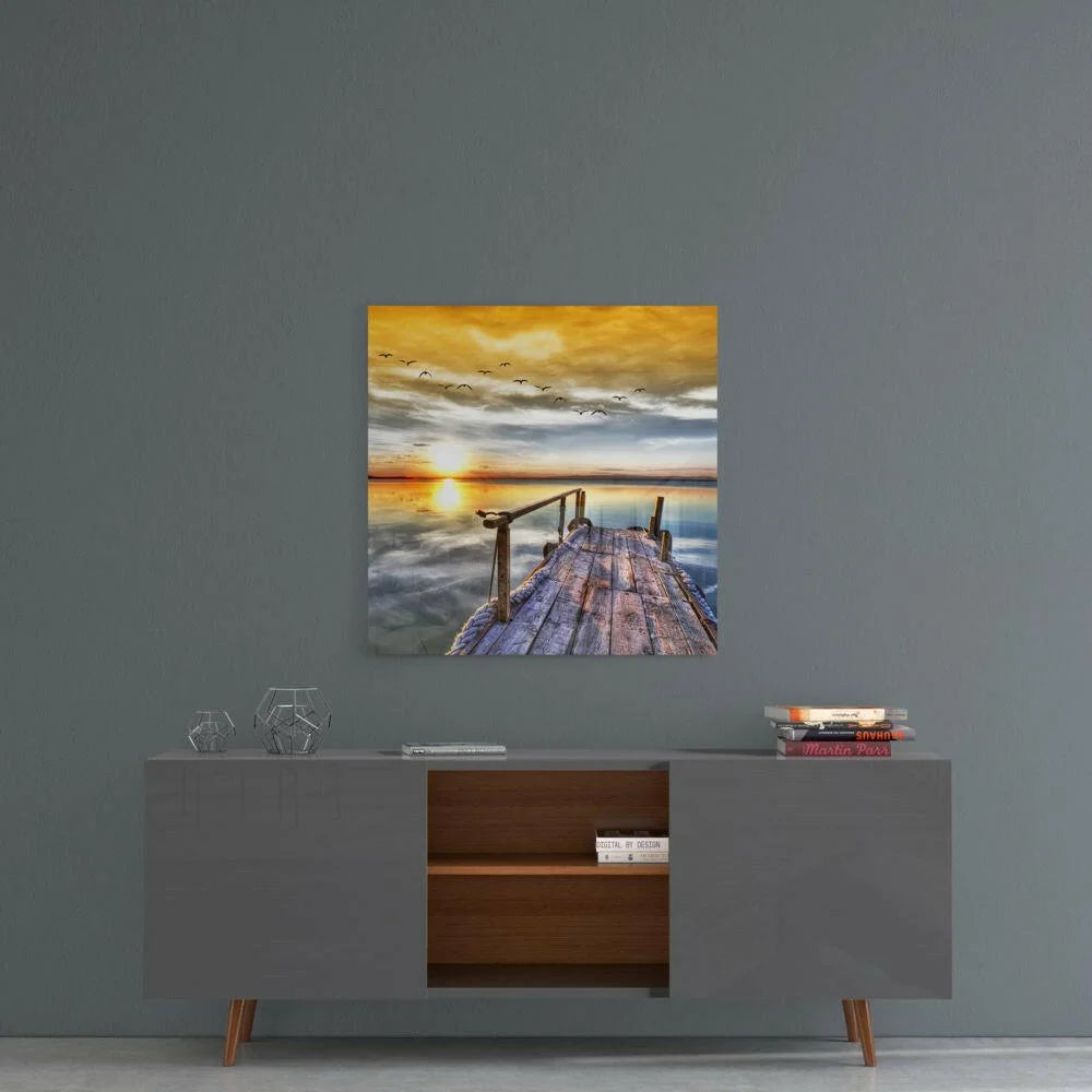 Sunset dock glass wall art with golden sky and birds