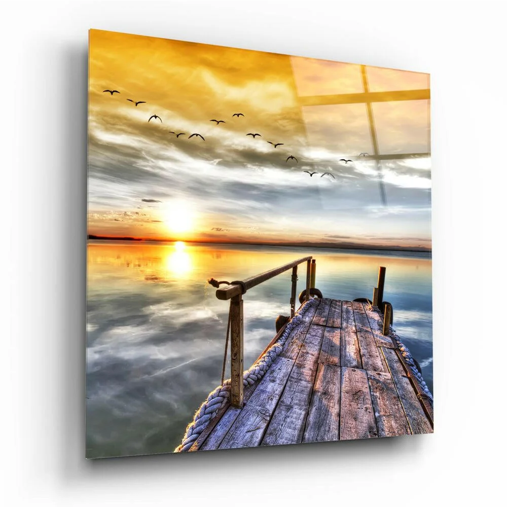 Serene sunset glass wall art with dock, golden sky, and birds