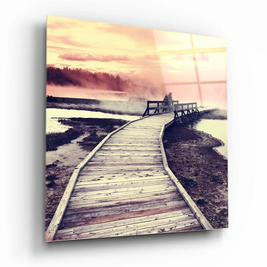 Sunset boardwalk glass wall art with misty pink waters