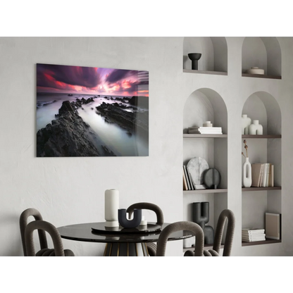 Vibrant purple pink sunset over rocky coast glass wall art print