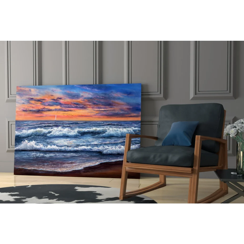 Vibrant sunset ocean waves glass wall art with sailboat leaning on gray wall