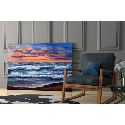 Vibrant sunset ocean waves glass wall art with sailboat leaning on gray wall