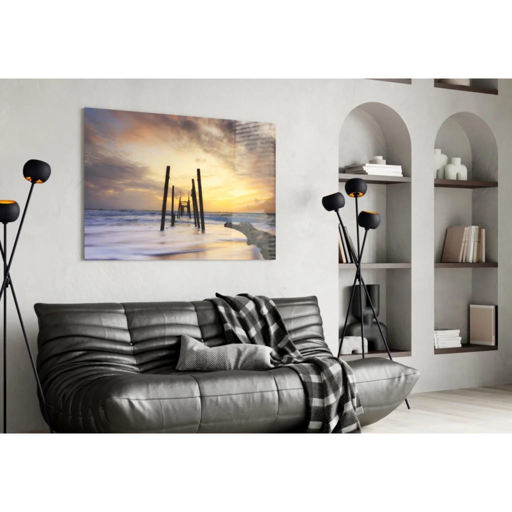 Modern leather sofa with black gray plaid throw and Sunset Pier glass wall art