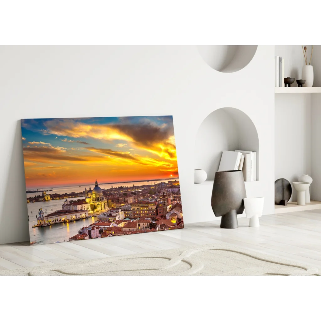 Vibrant sunset glass wall art print of golden skies over city buildings
