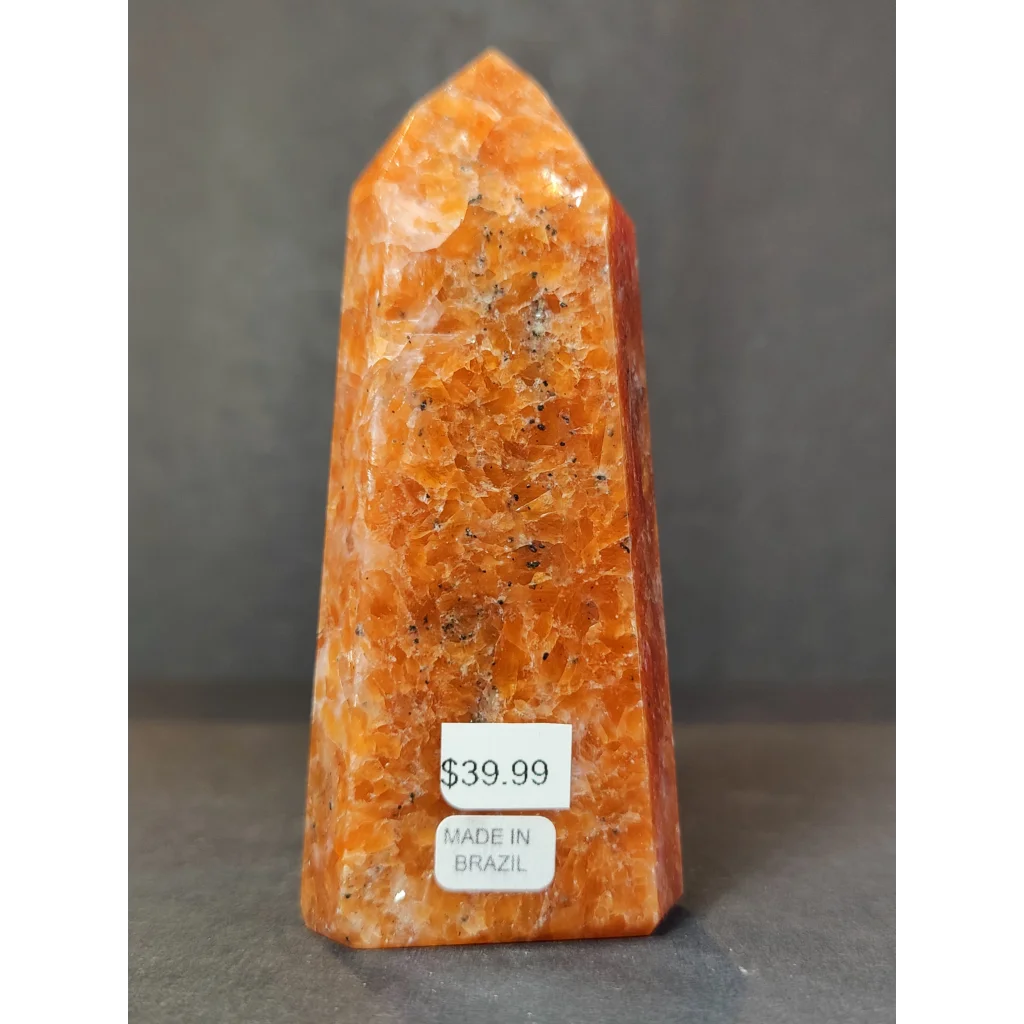 Sunstone polished obelisk tower sculpture in polished orange calcite with natural mineral inclusions and pointed top