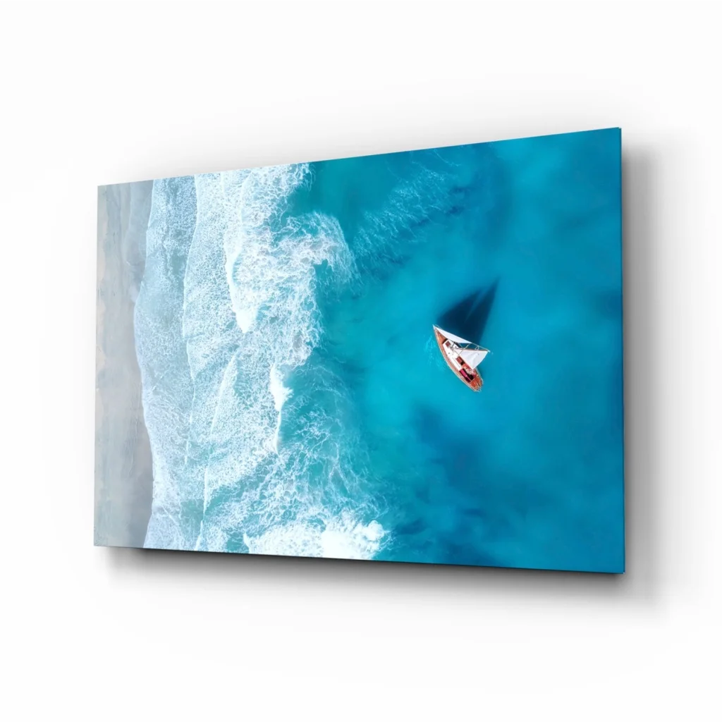 Aerial view of sailboat gliding on turquoise ocean wall art print