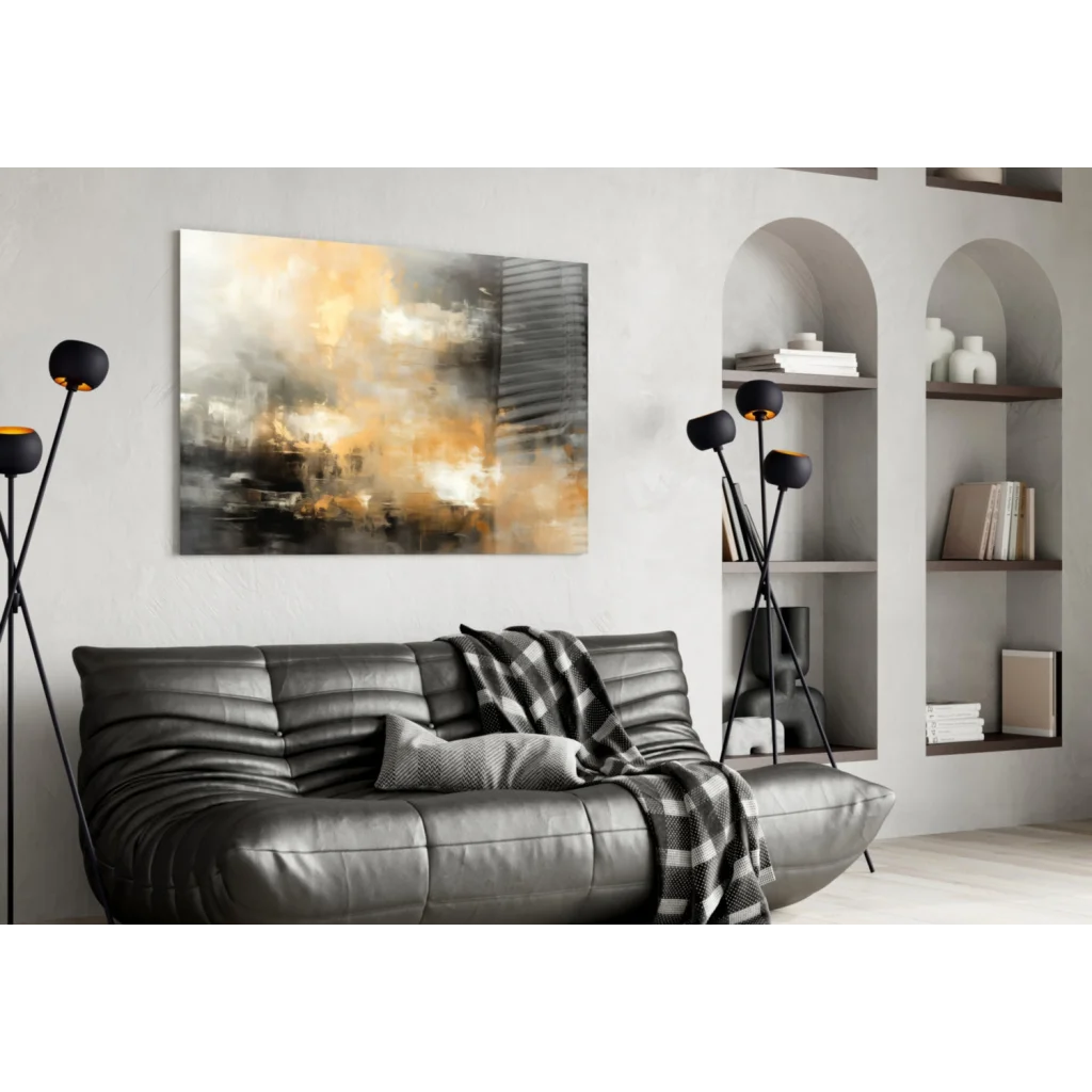 Black leather sofa with tufted cushions and plaid throw, near swirling abstract wall art