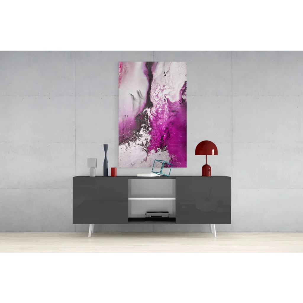Swirling magenta glass wall art with vibrant abstract hues above gray console