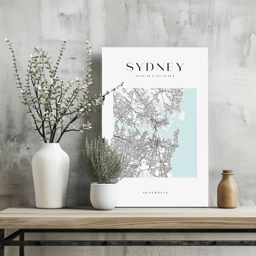 White Sydney map aluminum print with blue watercolor accents on wooden shelf