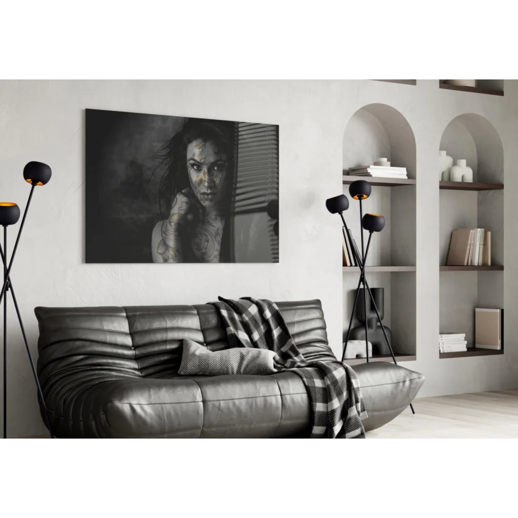 Stunning tattooed woman black and white portrait on glass wall art above gray sofa