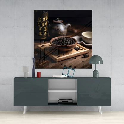 Rustic wooden bowl of dark loose-leaf tea on tray, styled with tempered glass art
