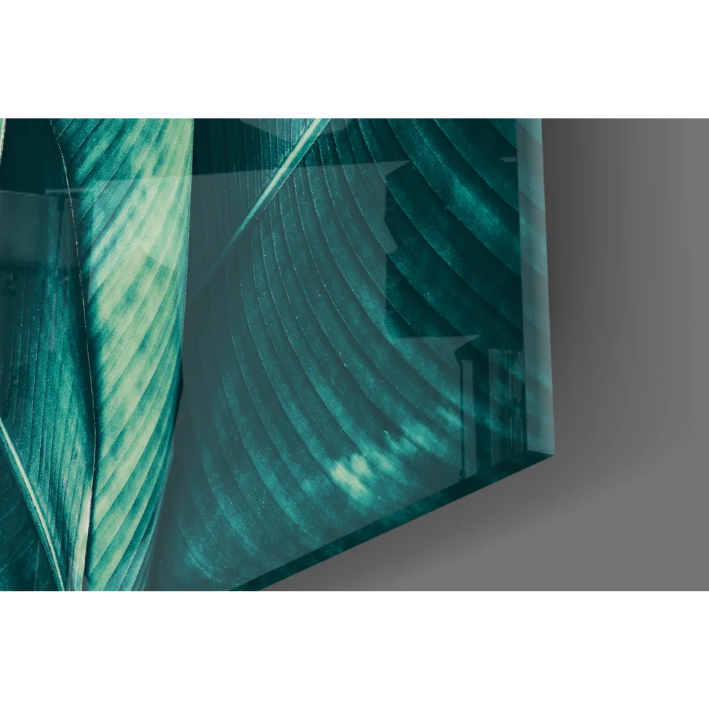 Teal banana leaf glass wall art with translucent etched patterns