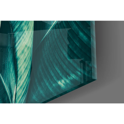Teal banana leaf glass wall art with translucent etched patterns