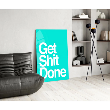 Teal Get Shit Done glass wall art motivational poster on black leather couch