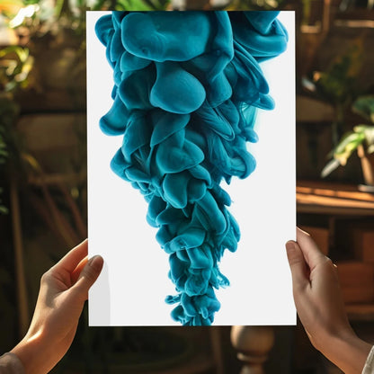 Hands holding vibrant teal ink swirl photo on Insigne aluminum print