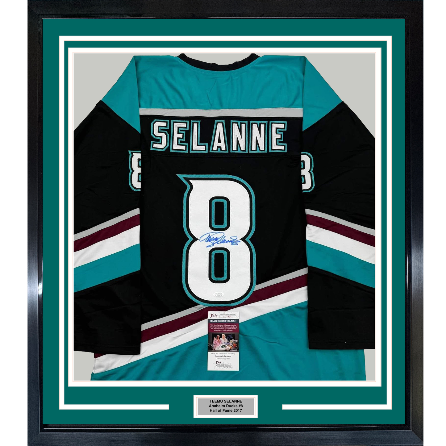 Framed black, teal, and white Anaheim Ducks hockey jersey number 8 signed by Teemu Selanne, displayed flat against teal matting with JSA certification label visible.