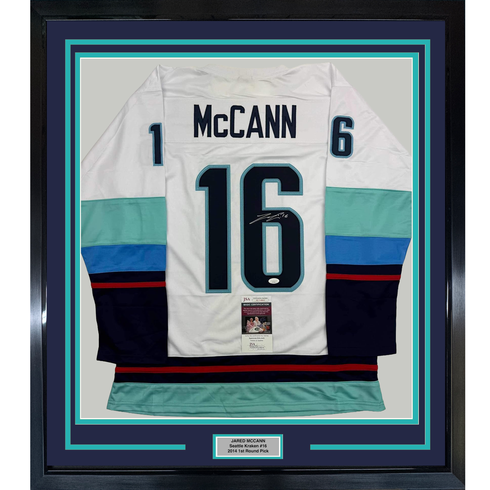 Framed white Seattle Kraken hockey jersey #16 with "McCann" nameplate, signed, displaying turquoise and navy striping with JSA authentication certificate.