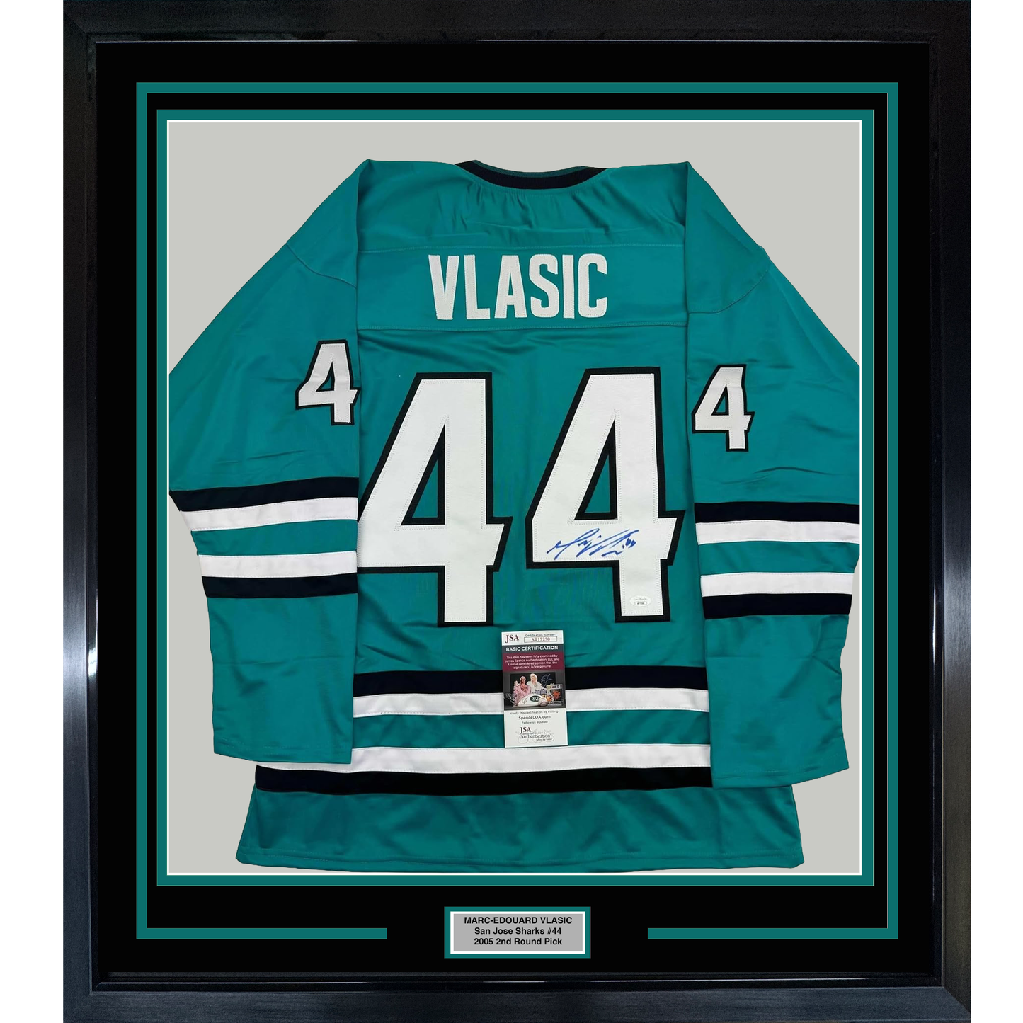 Framed teal San Jose Sharks jersey number 44 with "VLASIC" nameplate, signed, displayed flat against white backing with authentication certificate visible.