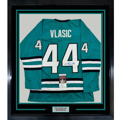 Framed teal San Jose Sharks jersey number 44 with "VLASIC" nameplate, signed, displayed flat against white backing with authentication certificate visible.