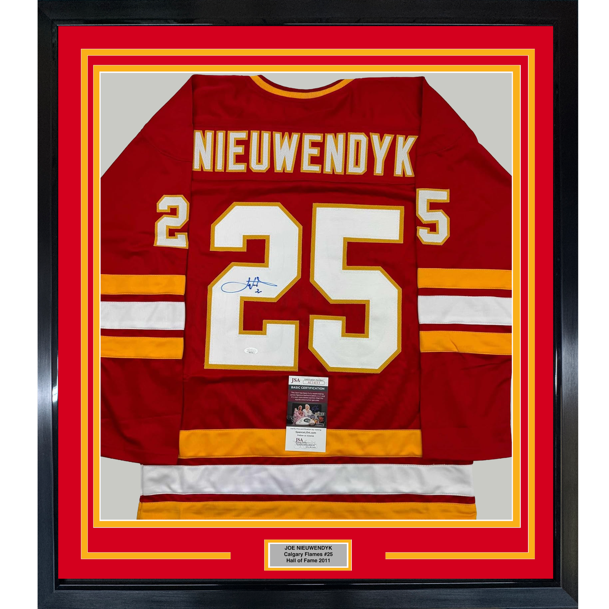 Framed red Calgary Flames hockey jersey number 25 with Nieuwendyk nameplate and signature, displayed front-facing with yellow and red border matting.