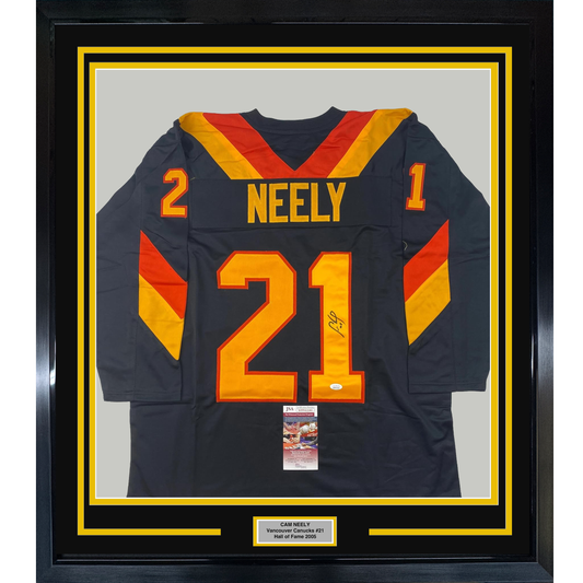 Framed Vancouver Canucks hockey jersey number 21 with "NEELY" nameplate, navy blue with red and gold trim, displayed front-facing with JSA authentication certificate visible.