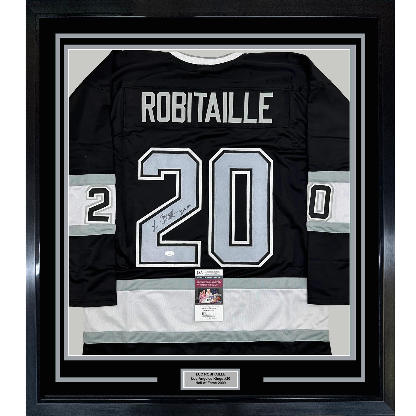 Framed black Los Angeles Kings hockey jersey #20 with "ROBITAILLE" across shoulders and signed number, displaying JSA authentication certificate below.