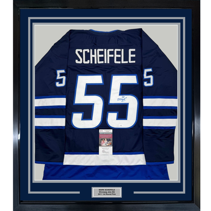 Navy blue Winnipeg Jets #55 hockey jersey with white and blue striping, displaying "SCHEIFELE" nameplate, framed with JSA authentication certificate visible at center bottom.