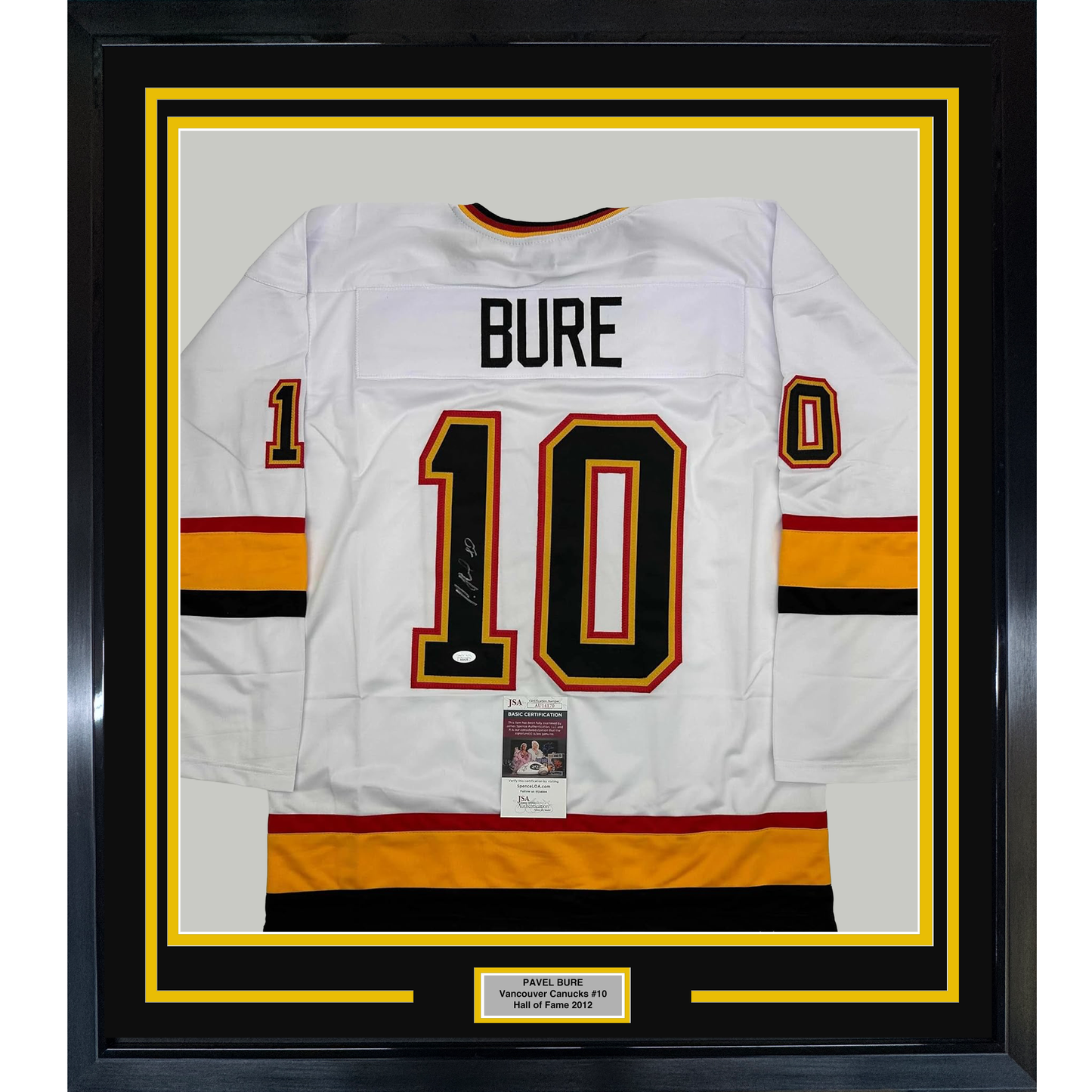 Framed white Vancouver Canucks hockey jersey number 10 with "BURE" nameplate and signature, displayed front-facing with yellow and black matting.