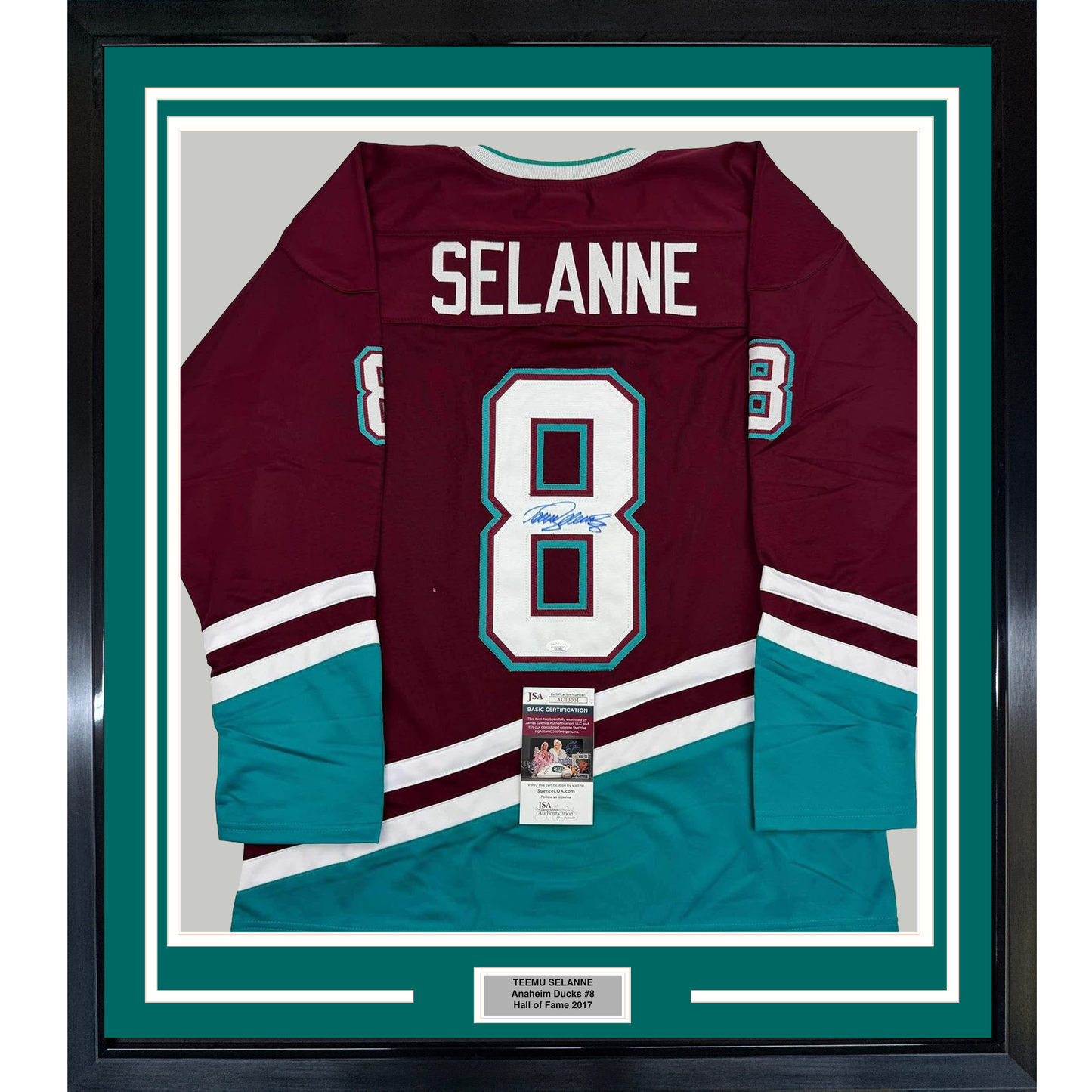 Framed maroon and teal Anaheim Ducks hockey jersey number 8 signed by Teemu Selanne, displayed flat against white matting with authentication certificate visible.