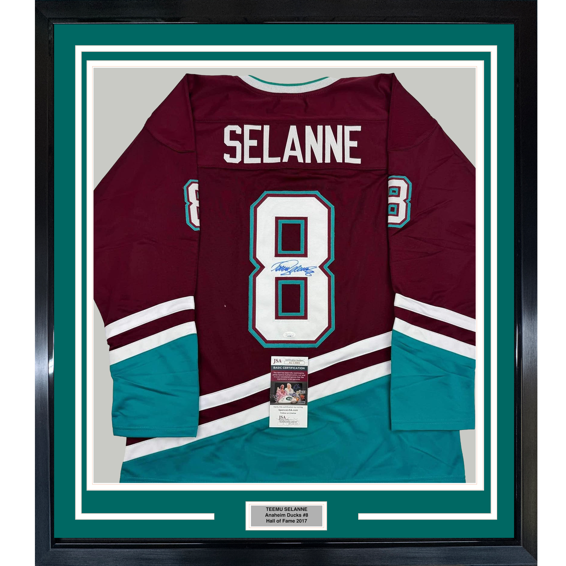 Framed maroon and teal Anaheim Ducks hockey jersey number 8 signed by Teemu Selanne, displayed flat against white matting with authentication certificate visible.