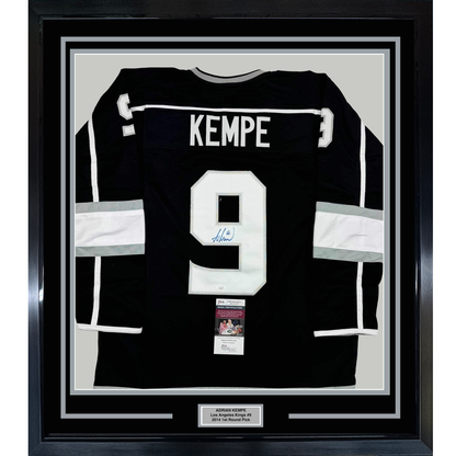 Black Los Angeles Kings jersey number 9 signed by Adrian Kempe, displayed framed with white matting and JSA authentication certificate.