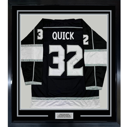 Framed black Los Angeles Kings hockey jersey #32 with "QUICK" nameplate and autographed number, displayed flat against white matting in black frame.
