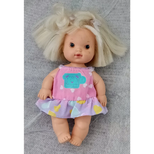 Vintage 1990 Cuddly Carly tot doll with blonde hair and pink heart dress