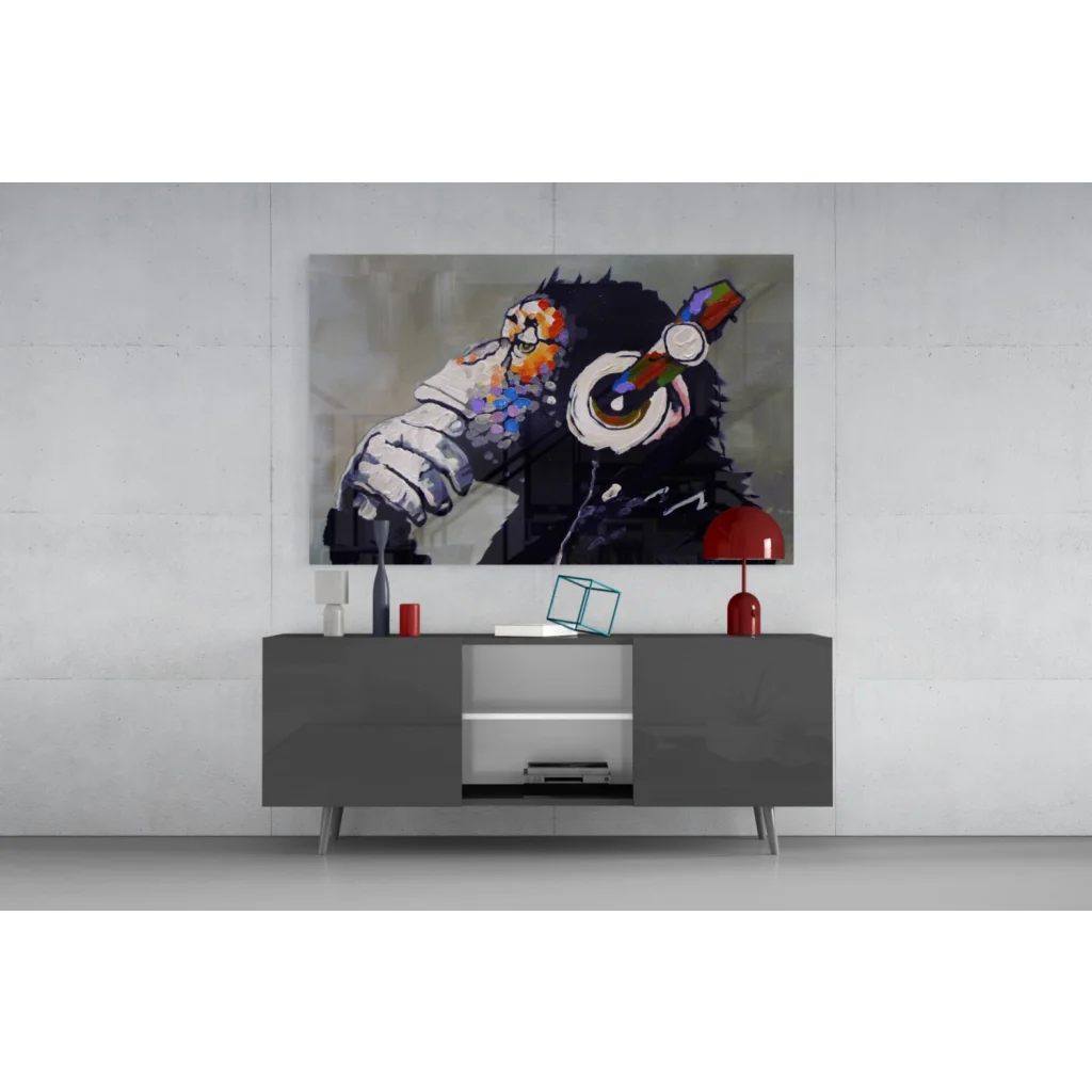 Vibrant glass wall art of black monkey in headphones above console