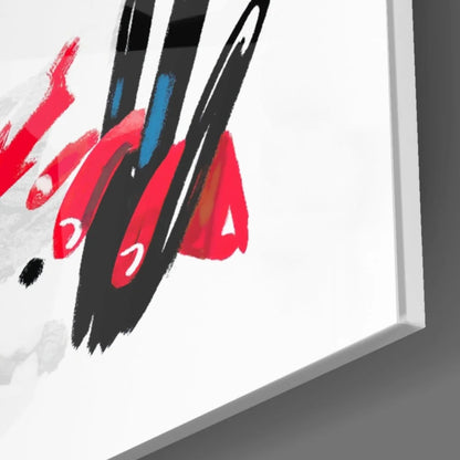 Bold abstract figure wall art with vibrant red, black, blue splashes on white canvas in sleek frame