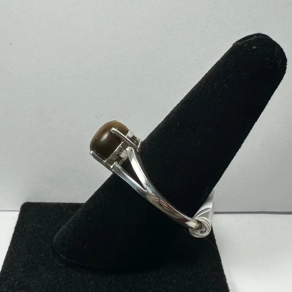 Elegant tiger eye ring with smooth oval brown gemstone in prong setting
