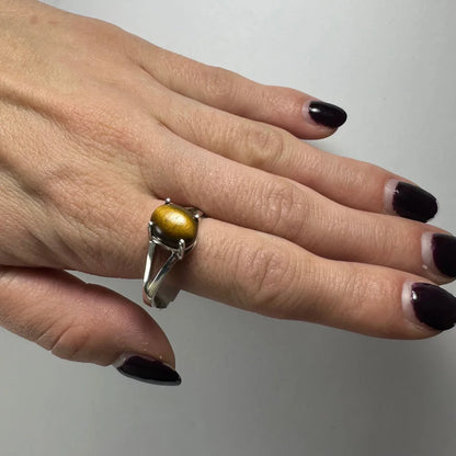 Sleek silver tiger eye ring with round golden stone in open-backed design