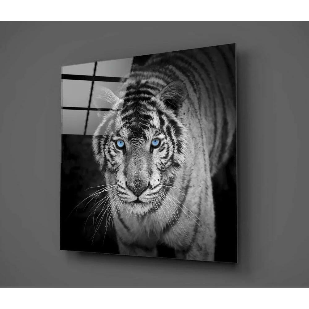 Mesmerizing white tiger glass wall art with piercing blue eyes on gray wall